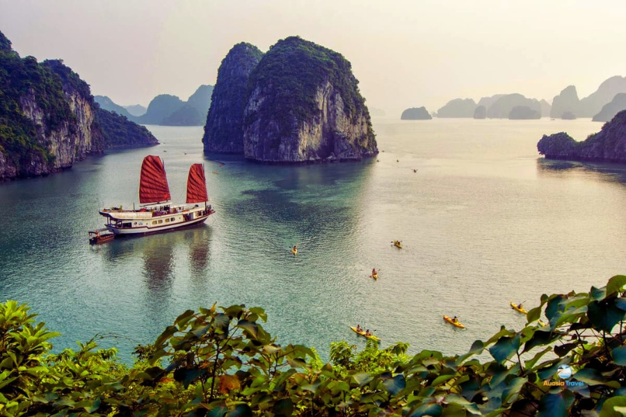 Scenic view of cruise ship sailing through limestone islands in Halong Bay – Auasia Travel